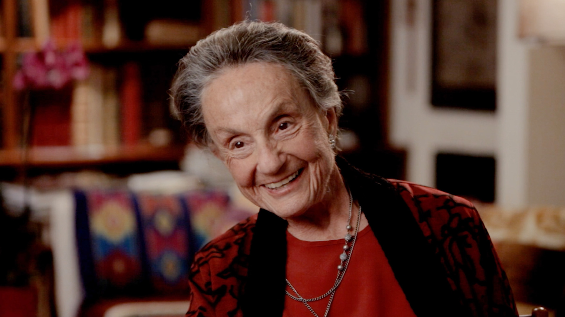 Color film still of older woman (Mara Vishniac Kohn) smiling.