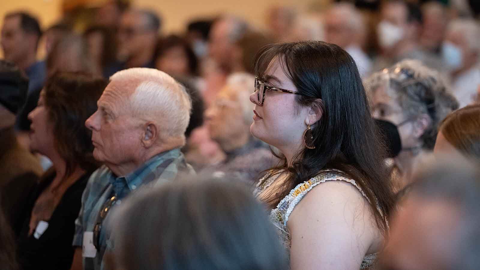 A young woman and older man in an audience